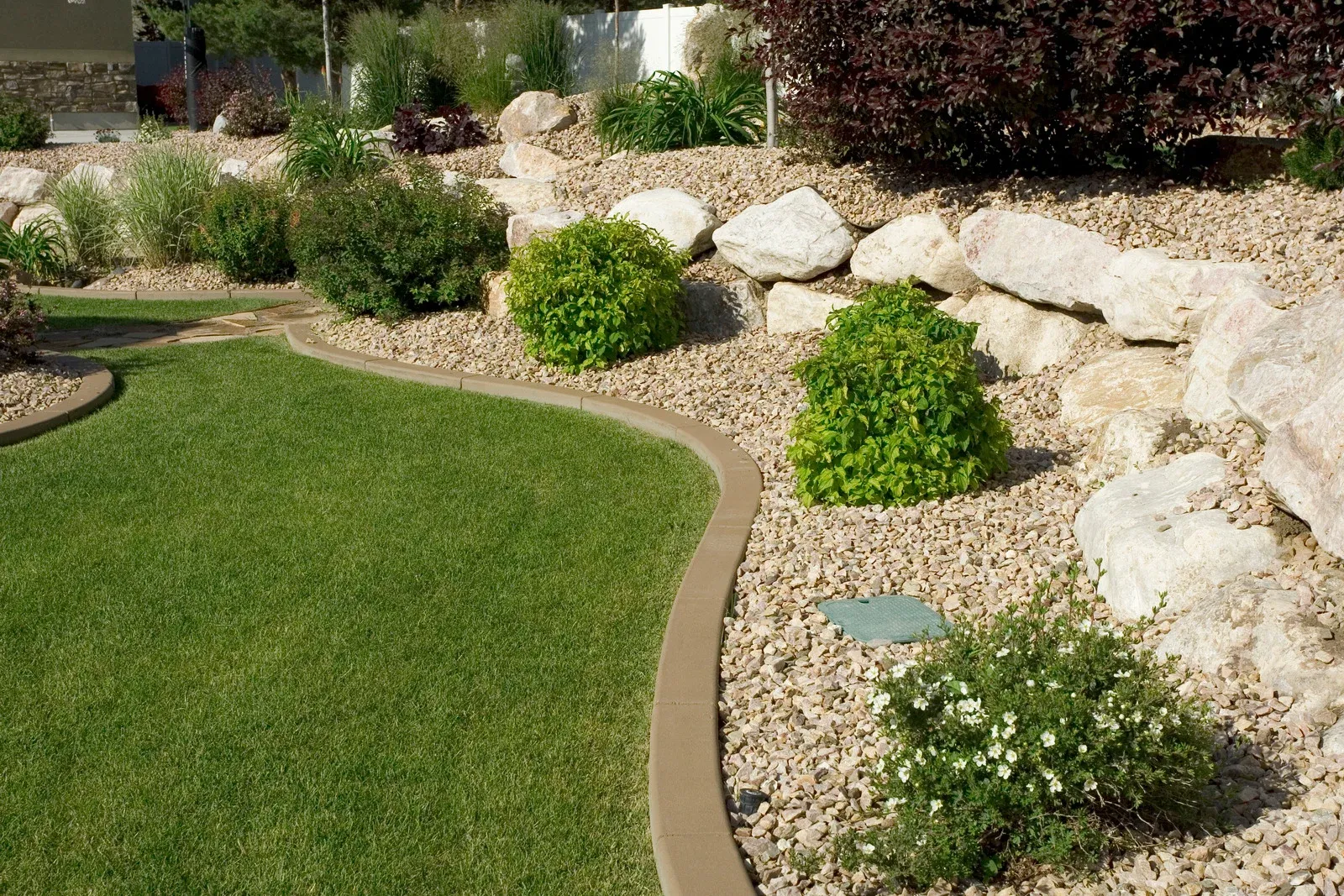 Quality Landscape project background showcasing stone and turf integration